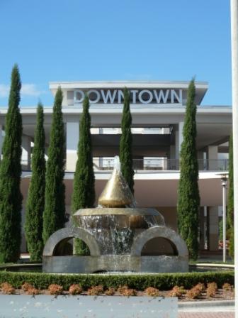 Abstract fountain with sculpture design outside a building with word 