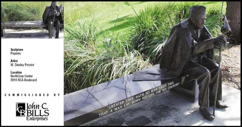 Statue of man sitting on bench with inscription 